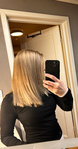Customer showing their smooth, shiny blonde hair after using the Grey Cover product.