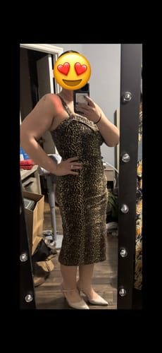 Reviewer showing a side view of the leopard print Maneater Wiggle Dress in a mirror selfie.