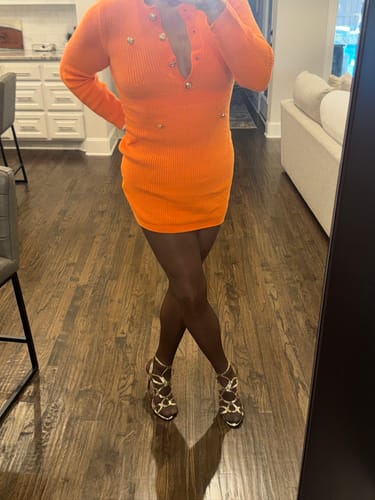 Reviewer standing with legs crossed, wearing dark, glossy PLAY seamless tights.