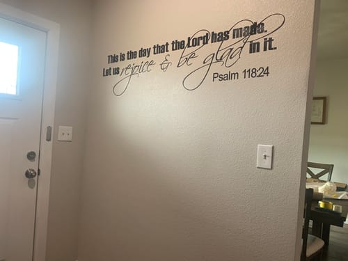 Customer's black Psalm 118:24 decal installed on a light-colored wall in a home entryway.