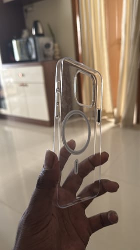 Reviewer holding a clear, transparent phone case with a visible magnetic ring in their hand.