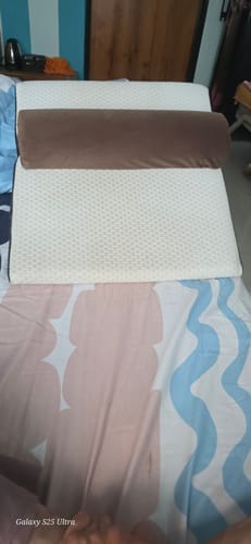 Customer's brown Frido Wedge Neck Rest Pillow placed on a larger wedge pillow on a bed.