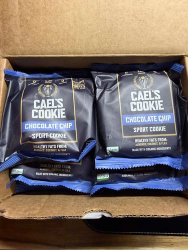 Customer's open box showing several individually wrapped Cael's Cookie Chocolate Chip sport cookies.