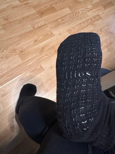 Customer showing the grip pattern on the sole of the black Dual-Direction Grip Basics.