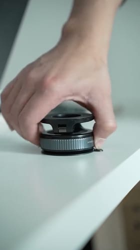 Reviewer holding the solid base of the black and silver MagPro Magnetic Phone Holder.