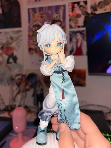 Customer holding their Nagi Windrider action figure, which has white hair and a detailed light blue and white outfit.
