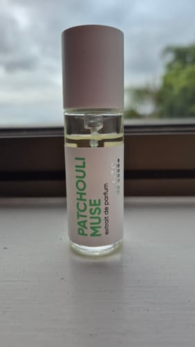 Customer's small sample bottle of Patchouli Muse perfume on a windowsill.