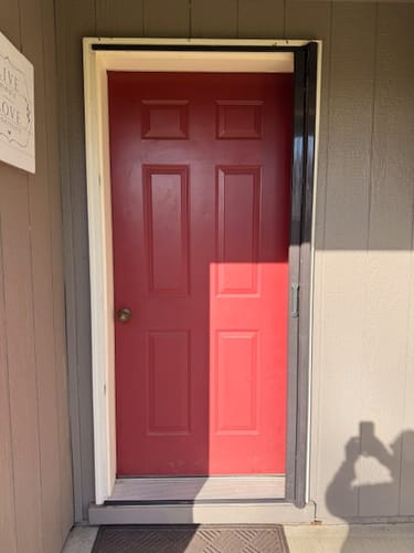Reviewer's solid red door from the outside before installing the Portland Glass and Frame Kit.