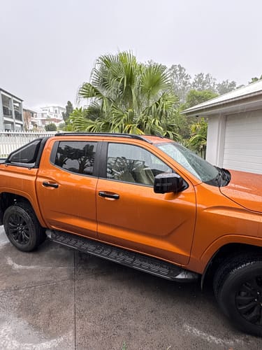 Customer's orange truck parked outside, providing context for the Waterproof Car Towel Seat Cover.