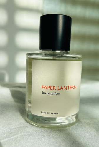 Customer's Paper Lantern perfume in a clear glass bottle with a simple black cap.