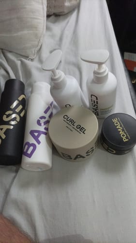 Reviewer's photo of hair products included in a bundle with the Toiletry Bag.