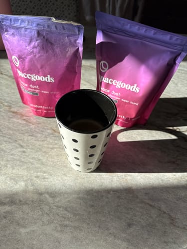 Customer's two bags of Rainbow Dust sit behind a polka-dot cup containing the prepared drink.