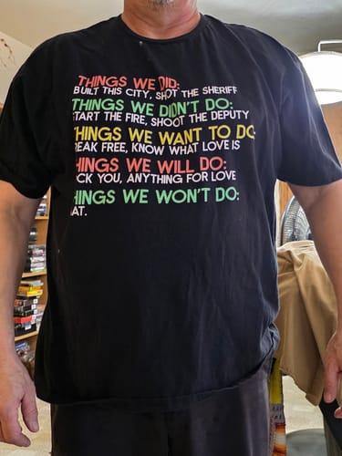 Customer wearing the black Things We Did T-Shirt, showing the fit and multi-colored text design on the front.