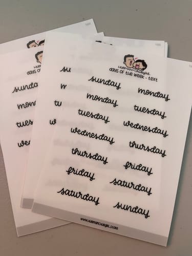 Reviewer's multiple transparent sheets of the Days of the Week Text Planner Stickers in a black script font.