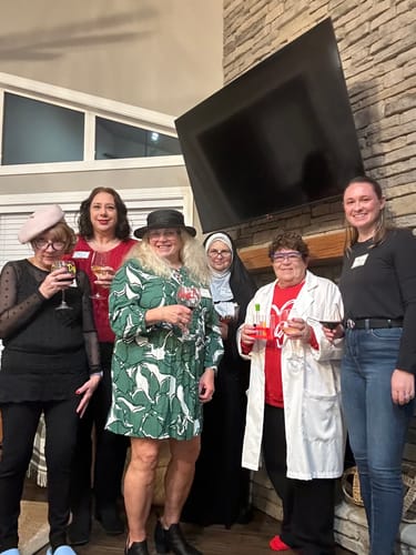 Customers in costumes, including a nun and a scientist, play the Wine Tasting Murder Mystery Game.