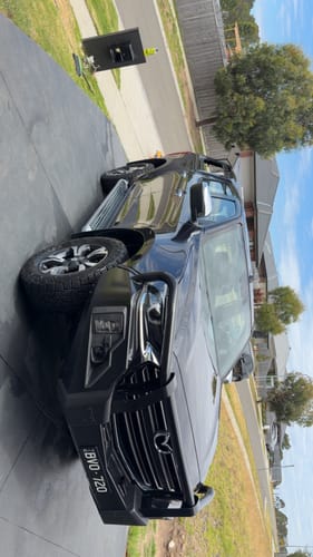 Customer's shiny black 4WD parked in a driveway after a wash with Salt Exterminator™.