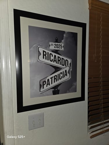 Customer's framed 'Couples Date of Love' canvas hanging on a wall. It features street signs with the names Ricardo and Patricia.