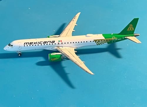 Customer's Gemini Mexicana ERJ195-E2 model airplane on a blue surface, showing the detailed white and green livery.