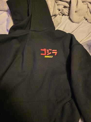 Customer's black Ramen Monster Hoodie laid flat, showing the red and yellow Japanese-style graphic on the chest.