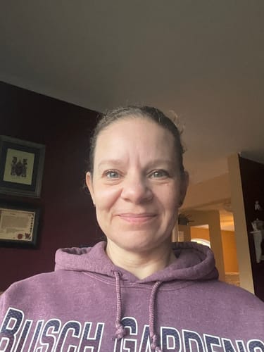 Reviewer smiling at the camera, showing her clear facial skin after using F-Balm.