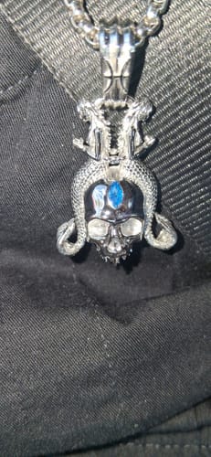 Customer's close-up of the silver Pisces Zodiac Pendant, showing a detailed skull with a blue gem.