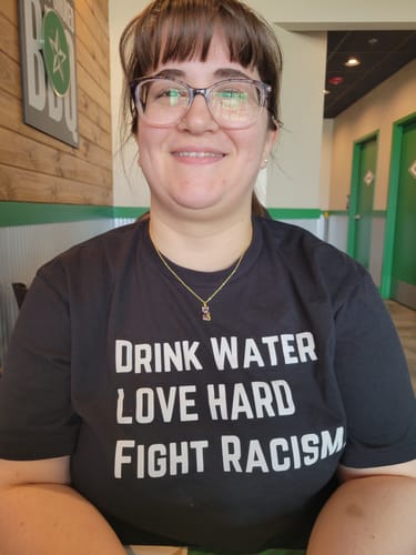 Customer photo review of Drink Water Fight Racism Unisex T-shirt