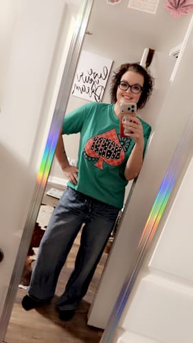 Reviewer in a mirror selfie showing the full-length, relaxed fit of the medium wash Judy Blue Palazzo Jeans.