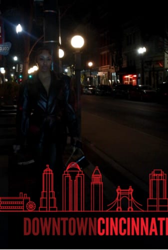 Customer wearing the sleek, black Vegan Leather Trench Romper for a night out in the city.