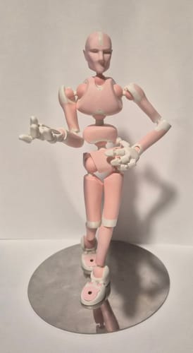 Customer's pink Rose Quartz Stickybones figure in a dynamic pose on a reflective stand.