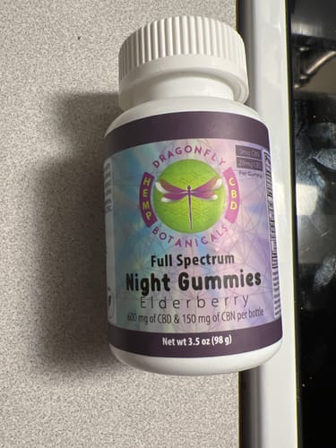 Customer's bottle of Full Spectrum Elderberry Night Gummies resting on a kitchen counter.