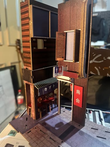 Customer's Omoide Yokocho Book Nook Kit during assembly, showing the detailed miniature Japanese alleyway.