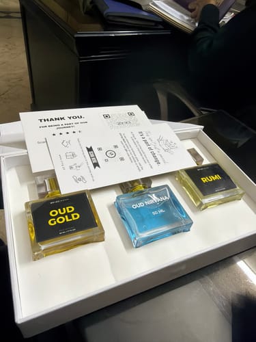 Customer's OUD Supreme BUNDLE showing three assorted perfume bottles neatly displayed in a white box.
