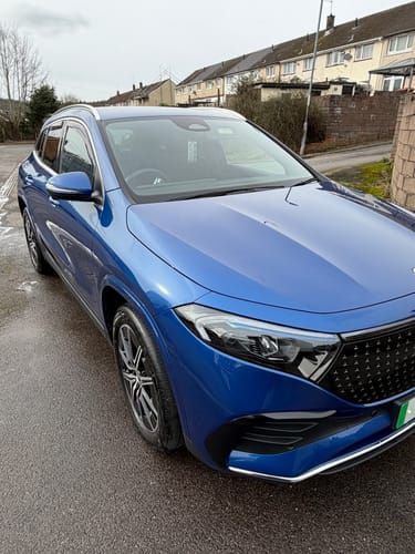 Reviewer's shiny blue car showing a high-gloss finish after applying the SiO2 Infused Ceramic Wax.