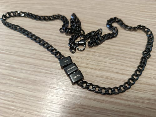 Customer's three black Legacy pendants, engraved with names, on a matching black chain necklace.