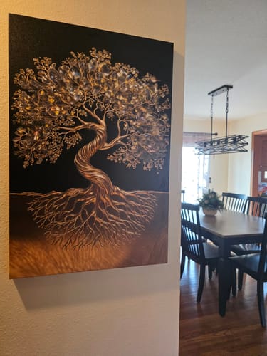 Customer's 3D Minimalist Tree of Life Wall Art with a textured, golden finish, hung on a wall next to a dining room.