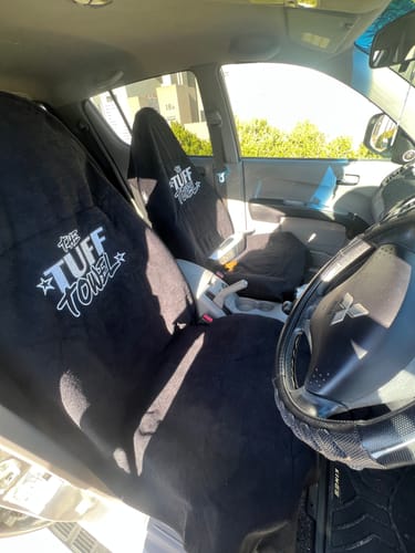 Reviewer's car with two black Waterproof Car Towel Seat Covers installed on the front seats.