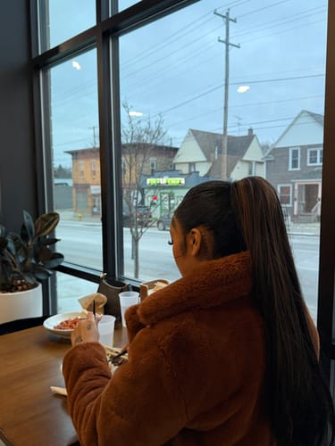 Reviewer seen from behind wearing the Sensationnel Lulu Pony in a high, straight ponytail.