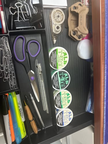 Customer's four tins of Chilled Mint Nicotine Pouches stacked in an office supply drawer.