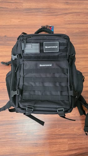Customer's black Tactical Backpack with multiple pockets and straps, displayed on a wood-style floor.