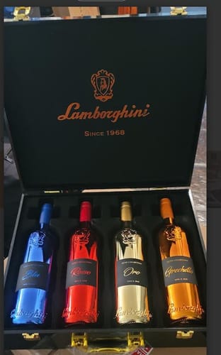 Reviewer's Lamborghini Limited LUXE Collection with four metallic wine bottles displayed in a black presentation case.