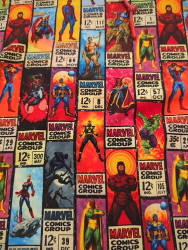 Close-up of the reviewer's 'Corner Box Brigade' hoodie fabric, showing the colorful retro comic book pattern.