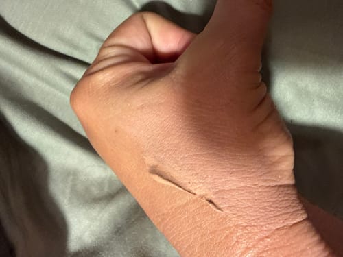 Close-up of a reviewer's hand showing a swatch of the Skinperfect Primer SPF30.
