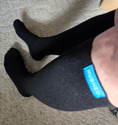 Reviewer's view of their black Performance Eucalyptus Compression Socks, showing the comfortable fit on their legs.