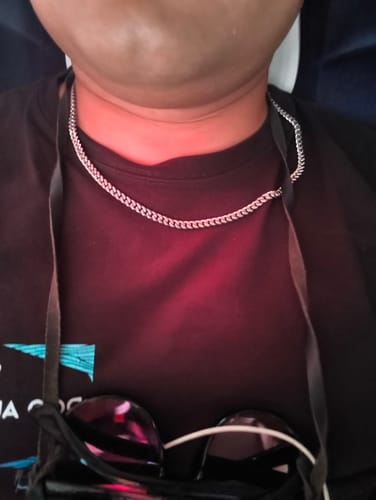 Primer plano de un cliente usando la Cadena Miami Cuban de 5mm sobre una camiseta negra.