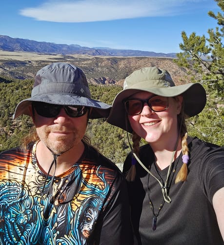 Customer smiling outdoors while wearing the purple Natural Fluorite Necklace.