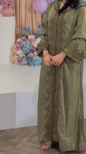 Customer showing the fit of the green Jellaba Souria with its detailed embroidery.