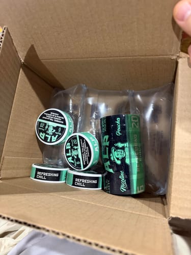 Customer's order of Refreshing Chill Nicotine Pouches in an open shipping box, showing several tins and a log.