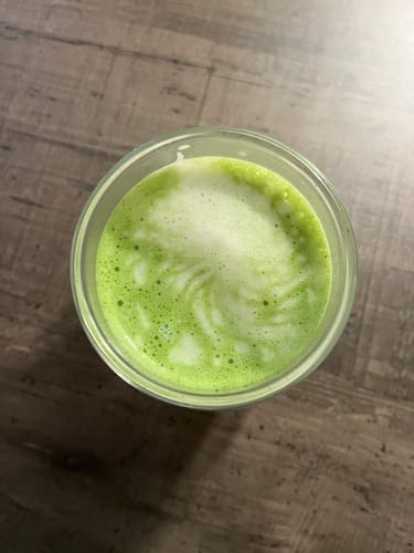Avis d'un client : gros plan sur un thé matcha cérémonie bio vert vif, avec une mousse onctueuse dans un verre.