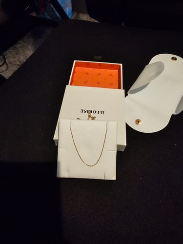 Customer's Diamond Cut Chain on a white display card with its open box and pouch.