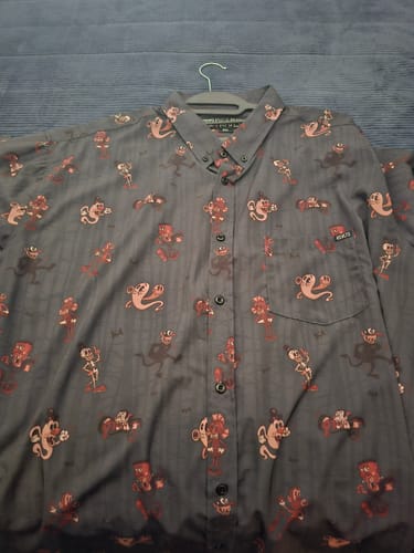 Customer's Spooky Soiree shirt laid flat, showing the detailed cartoon Halloween character print on the dark fabric.